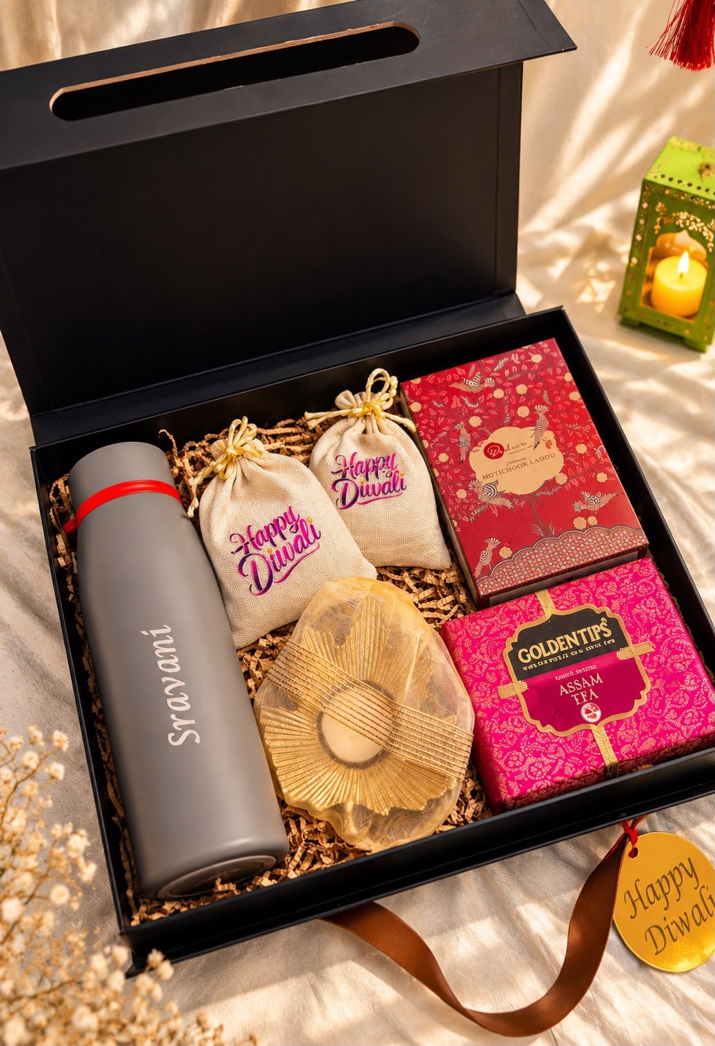 The Briefcase: black box with a name-engraved steel bottle, Happy Diwali potlis, motichoor laddu and Golden Tips Assam tea